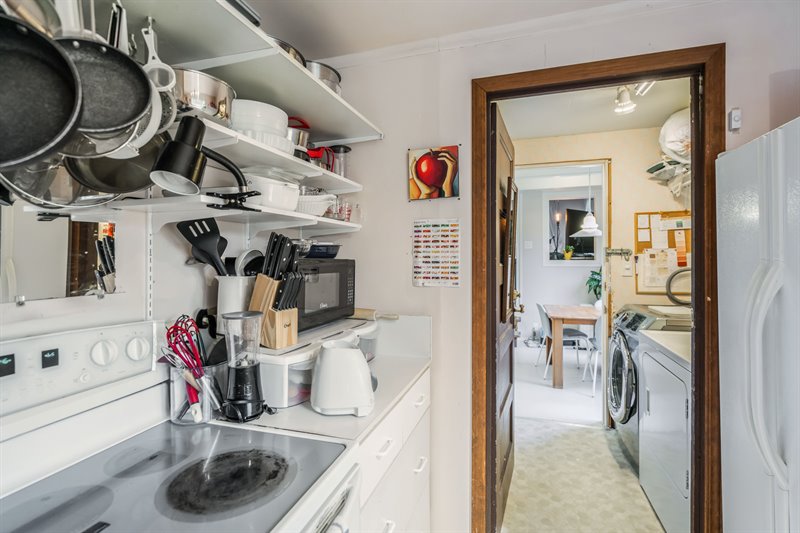 Dwelling # 1 - Kitchen & Door to Shared Laundry Room
